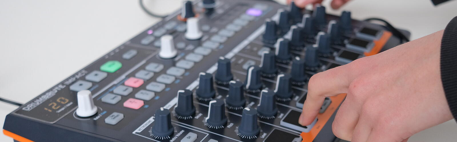 Ein Mensch bedient einen Synthesizer