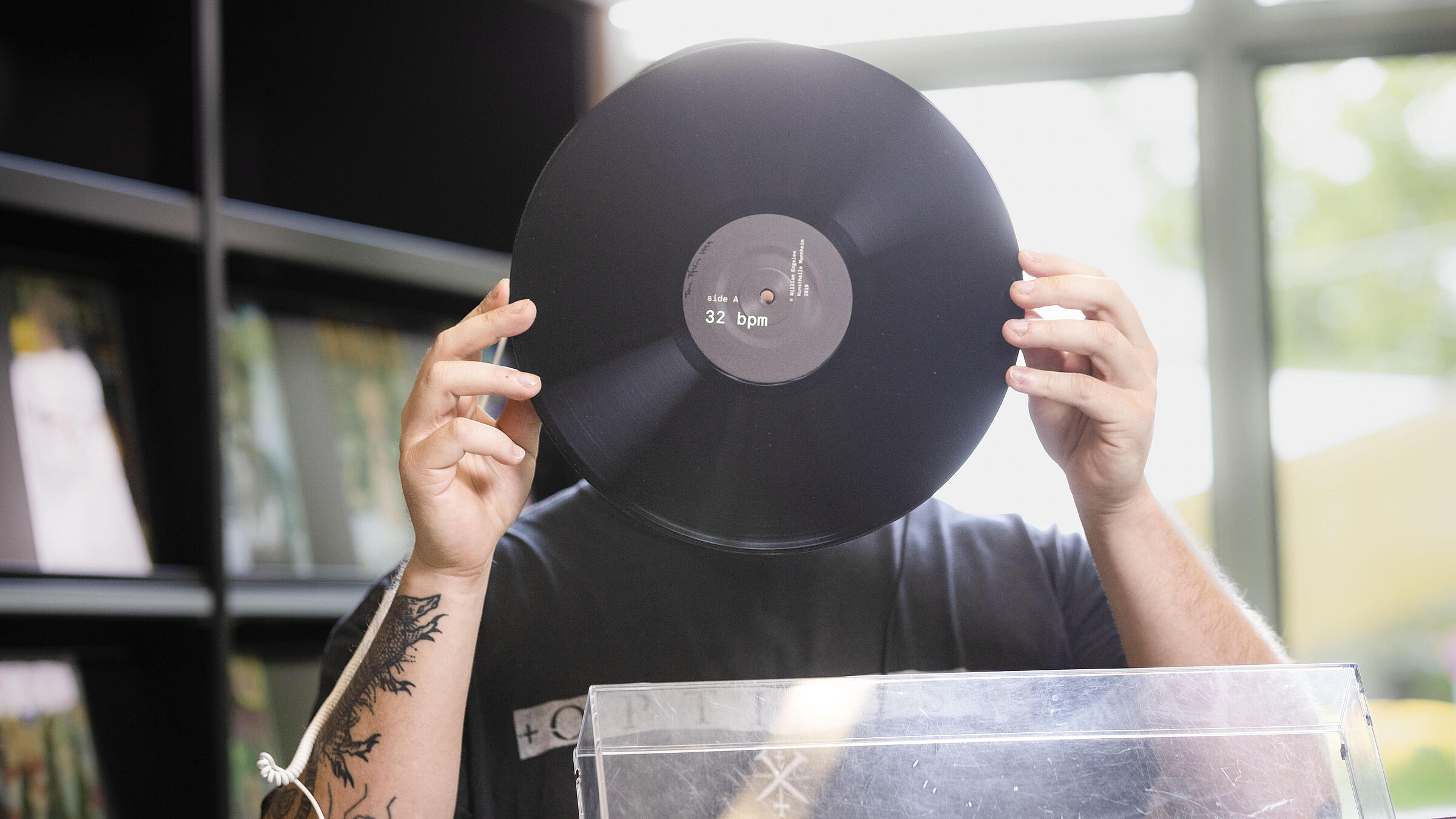 Man holds record in front of his face